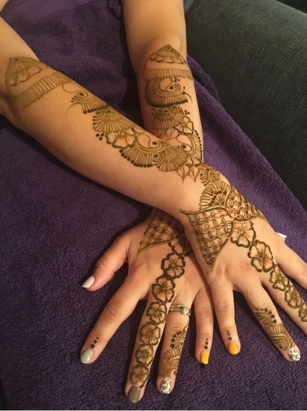 Crossed arms with bridal henna